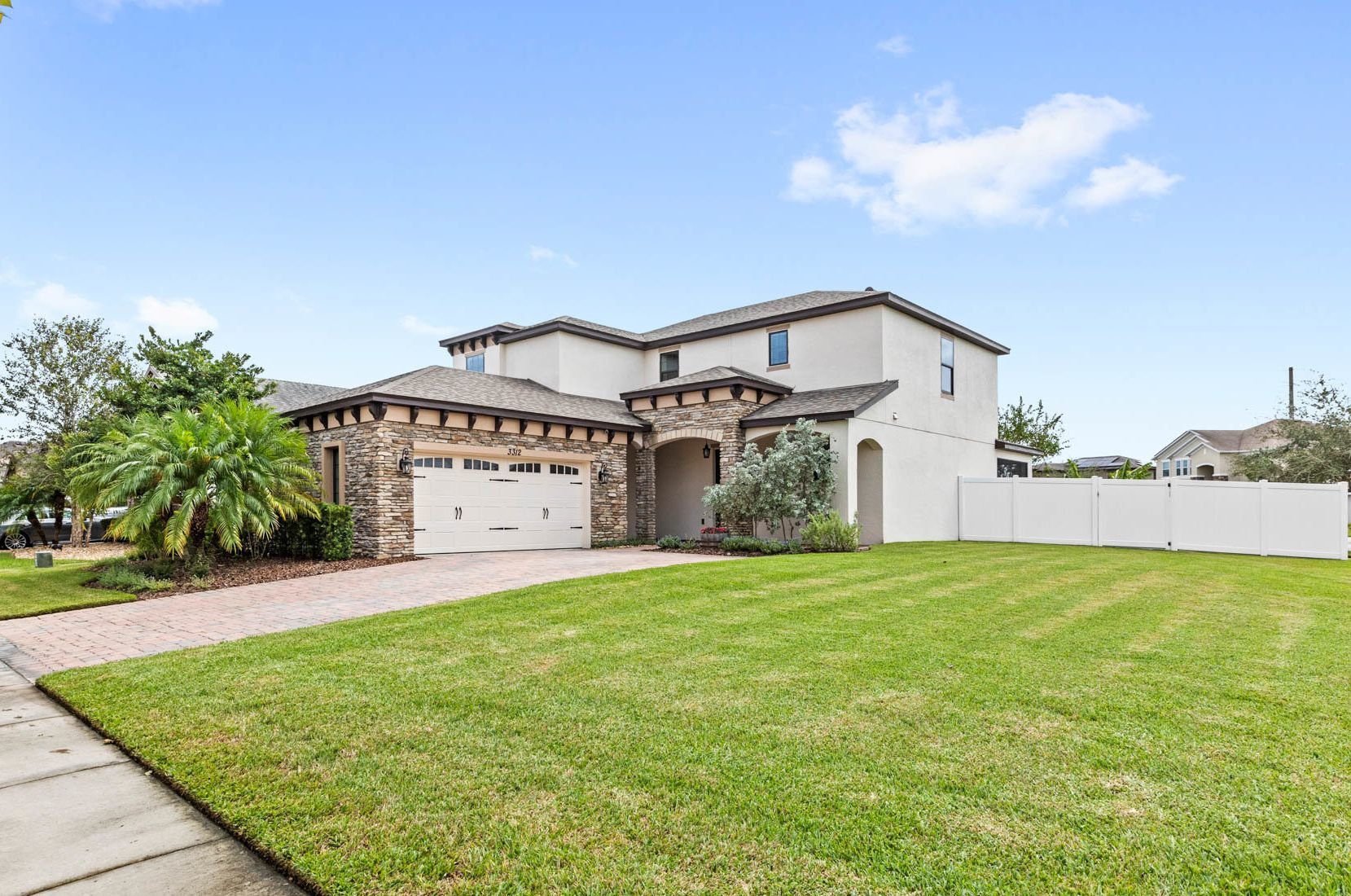front of home with large yard and green grass
